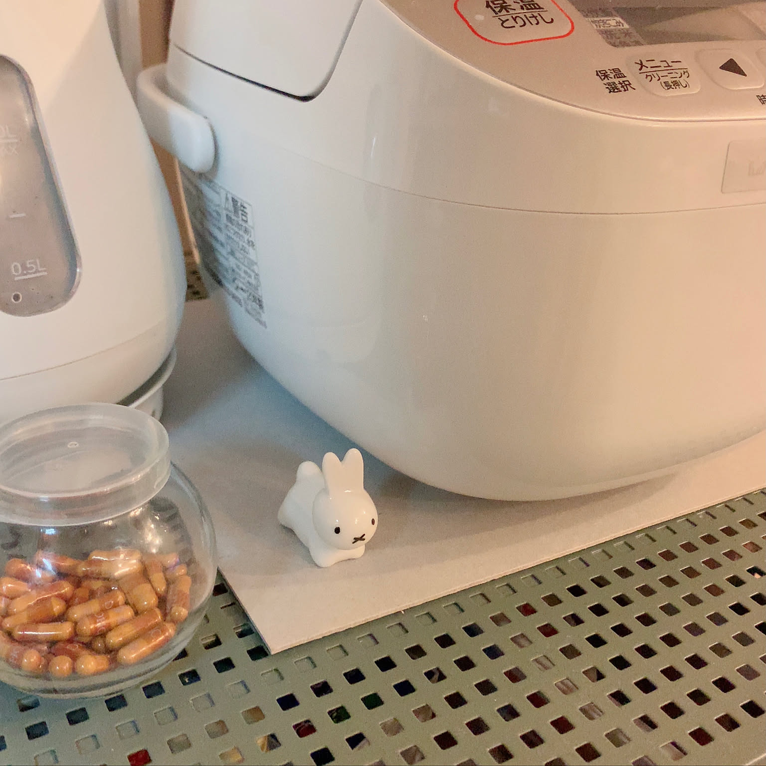 A close view of a white Zojirushi 3-cup rice cooker body and controls.