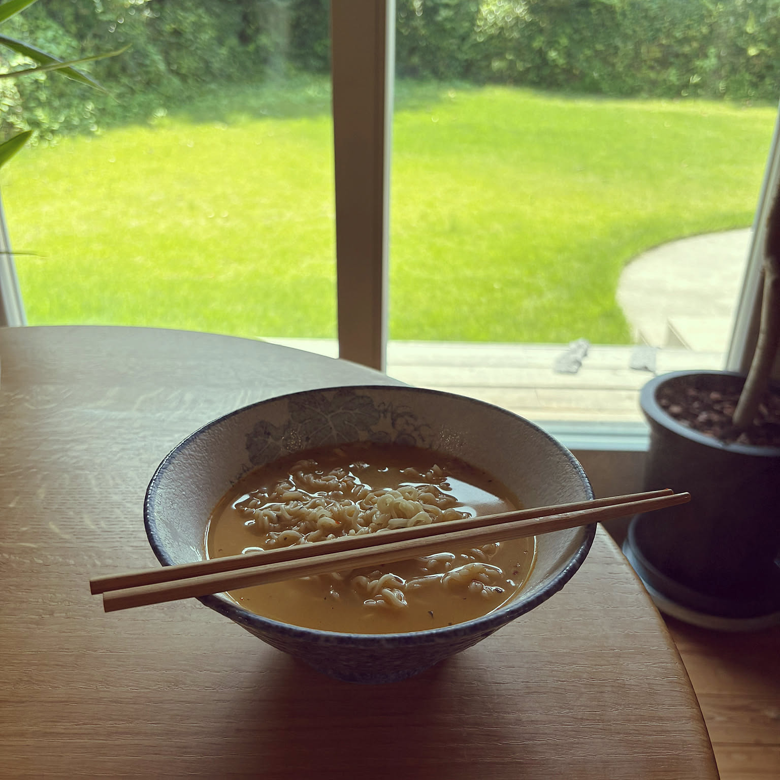 Ramen served in a wide bowl with chopsticks resting across the top.