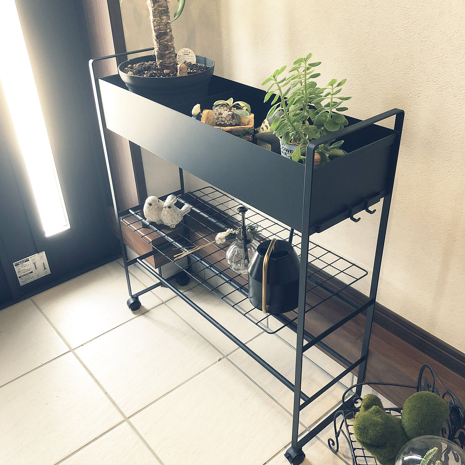 A slim rolling entryway storage cart used in a Japanese home for flexible daily overflow.