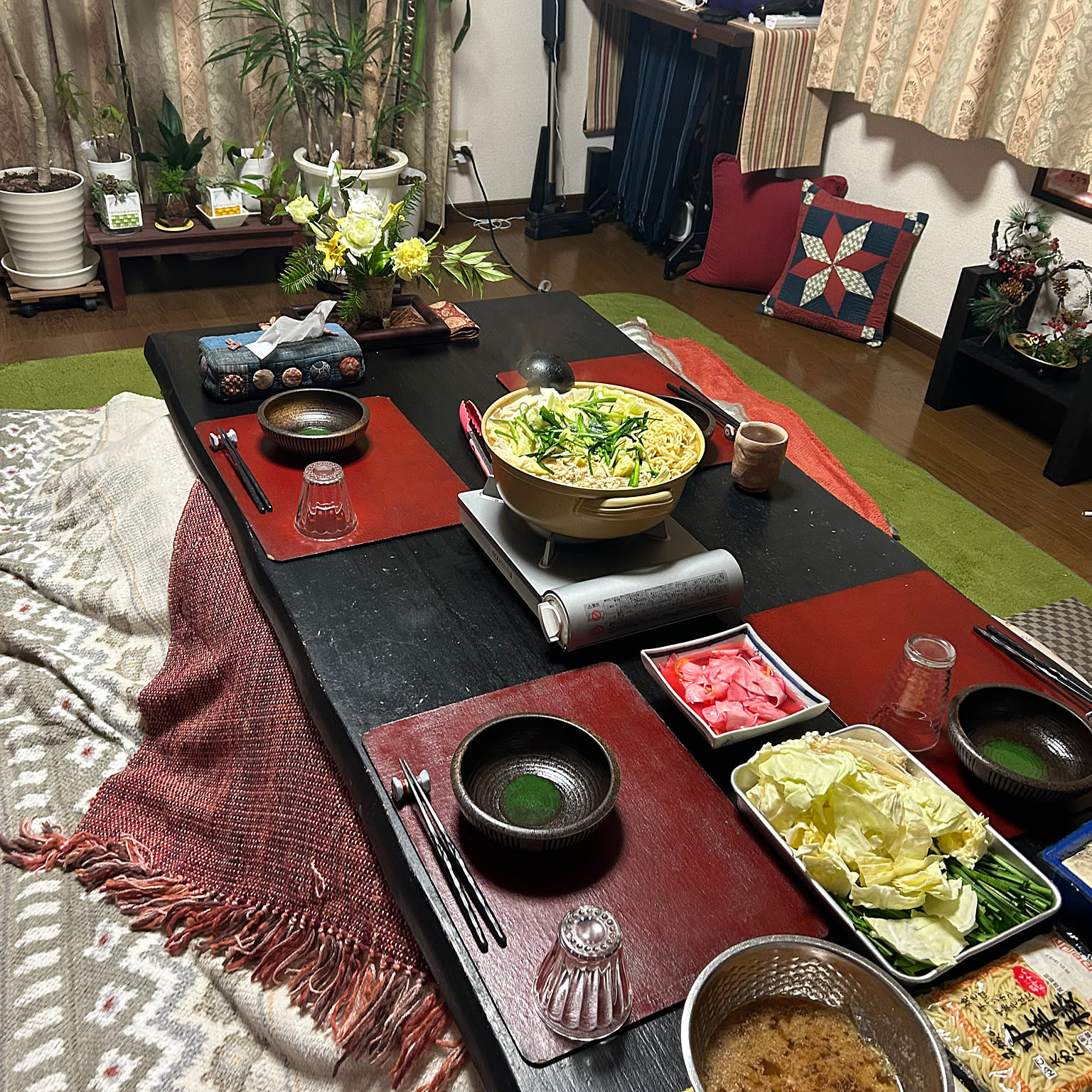 An Iwatani cassette stove used indoors for a hot pot dinner at a low table in a Japanese home.