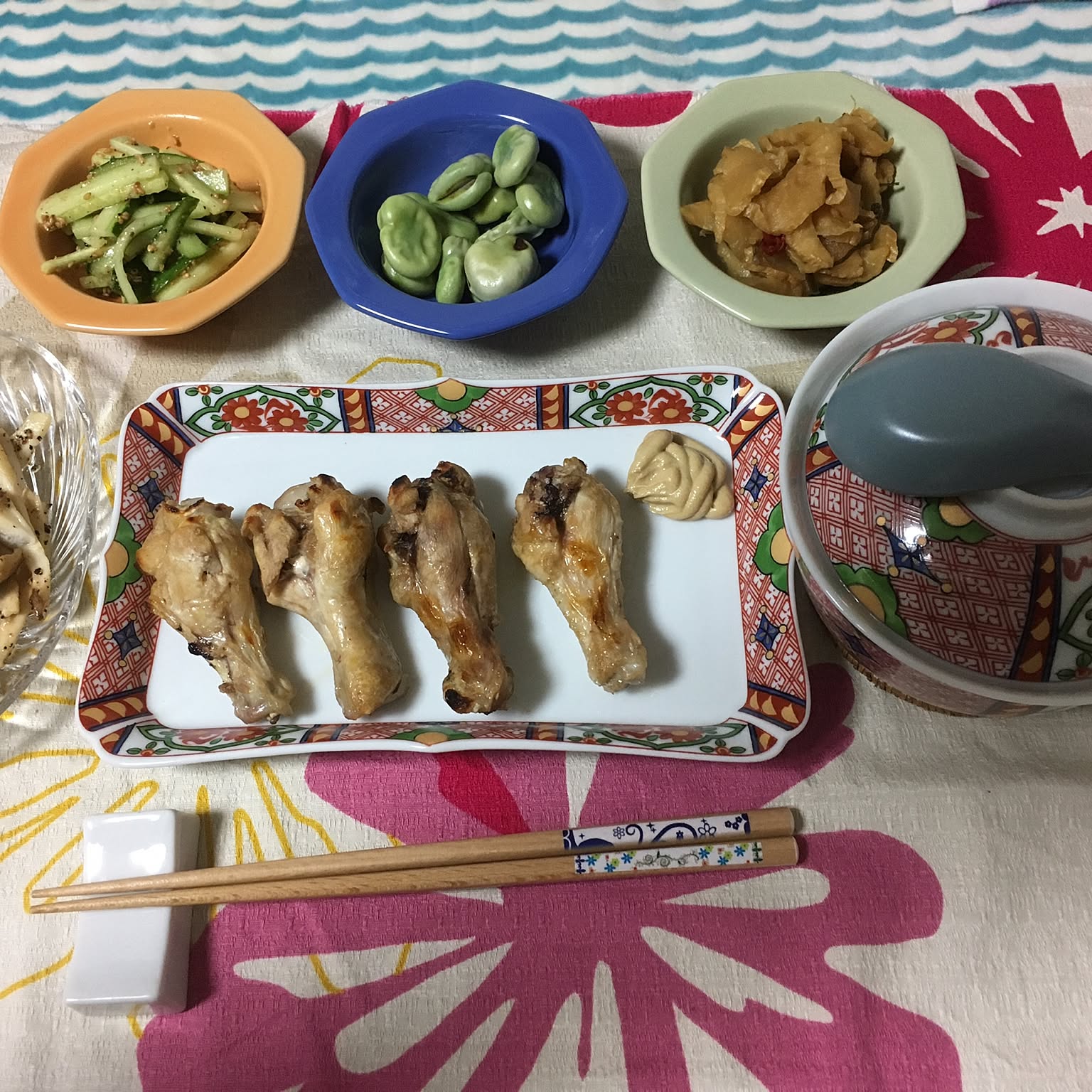 Small Japanese plates used for side dishes and snacks on a colorful table.