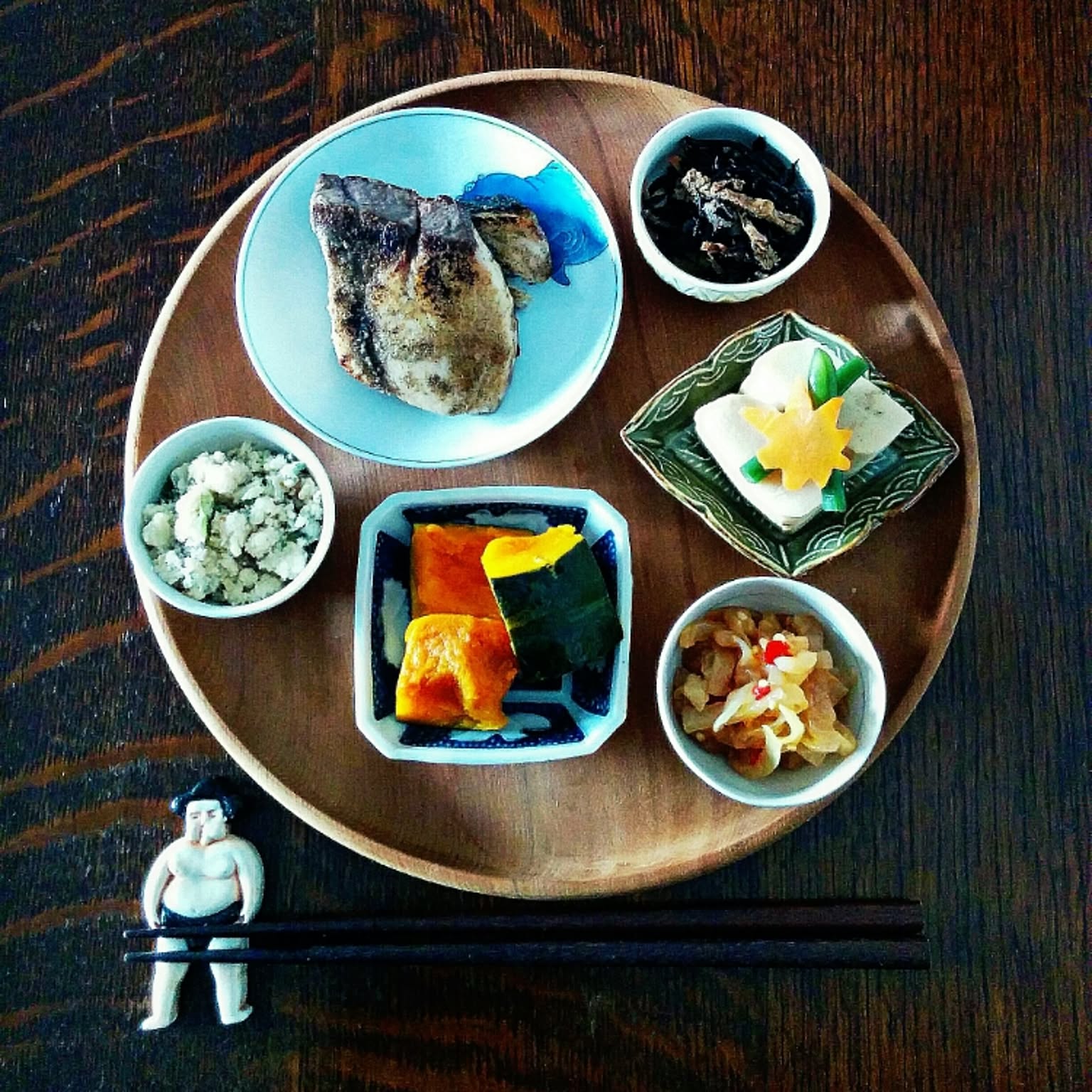 Japanese tray meal with several small plates holding side dishes.