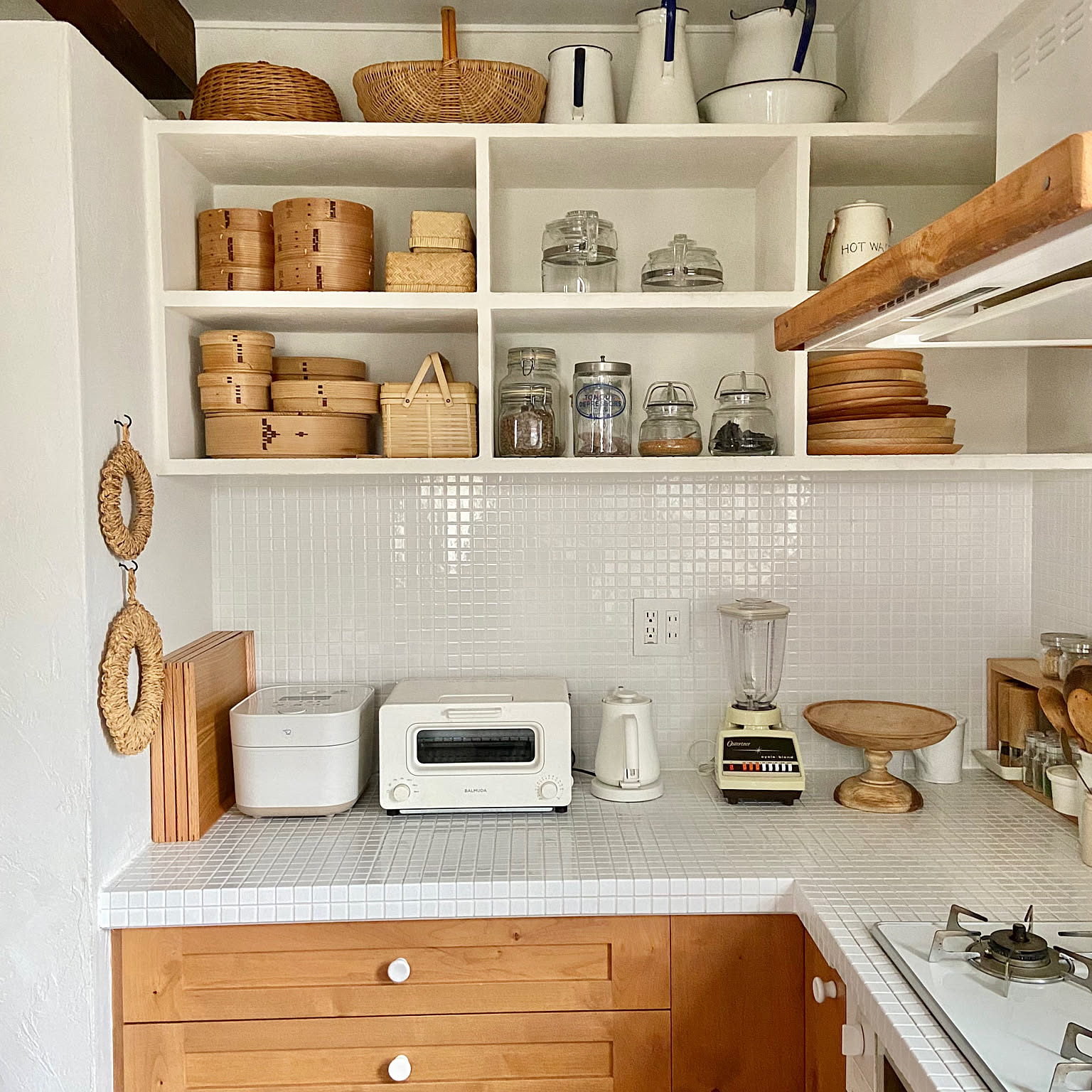 A white 5.5-cup Zojirushi STAN. rice cooker placed with other countertop appliances in a bright kitchen.