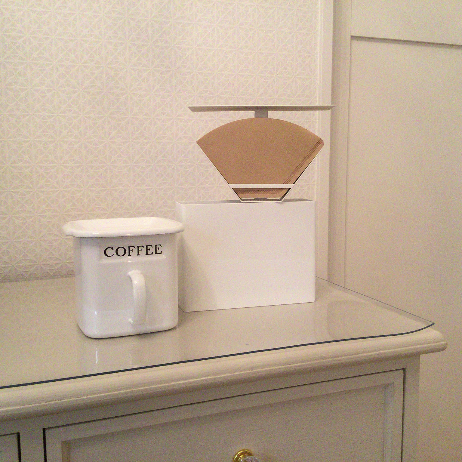 Yamazaki Tower coffee paper filter case holding paper filters on a shelf.