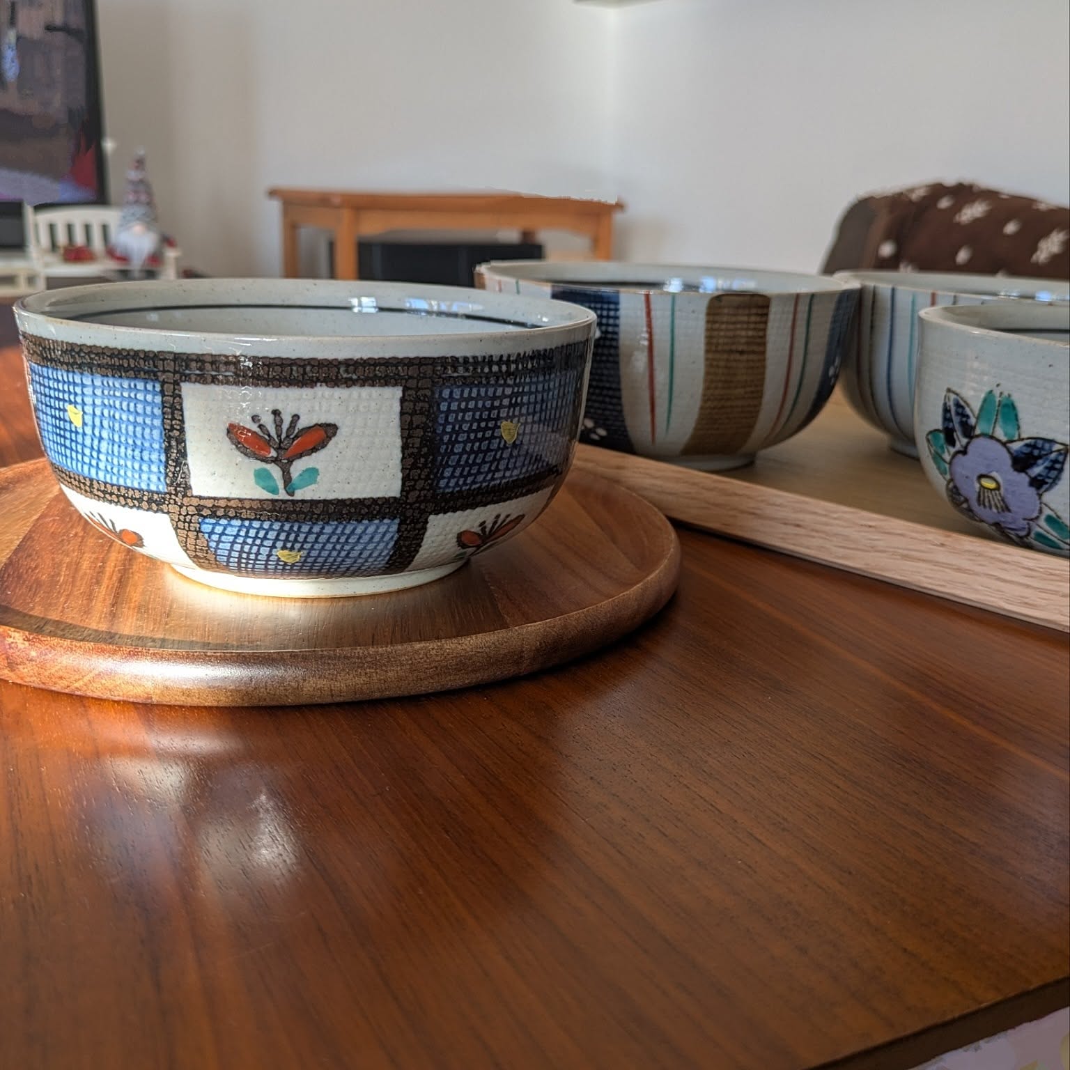 Decorated Japanese deep bowls on a wooden table.