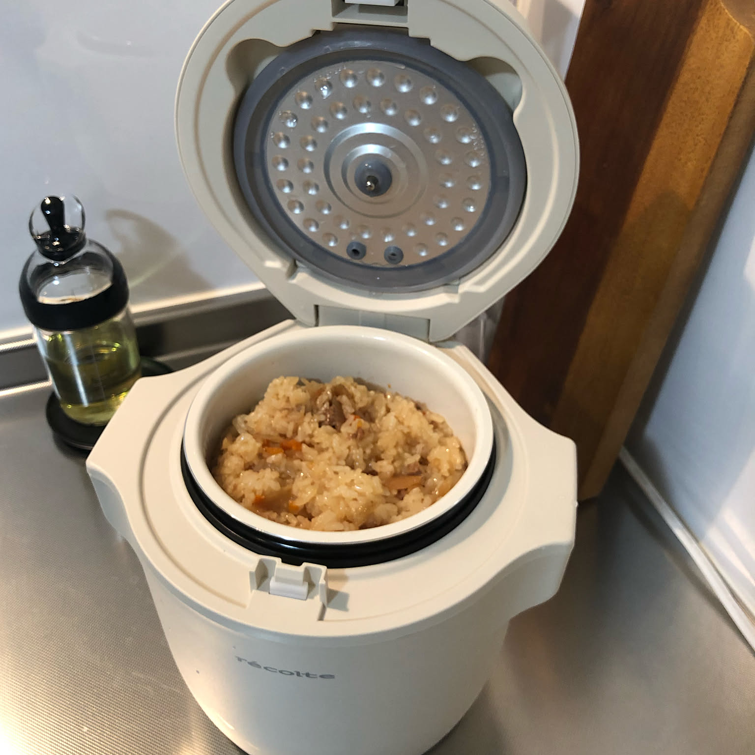 An open white Recolte compact rice cooker filled with cooked mixed rice.