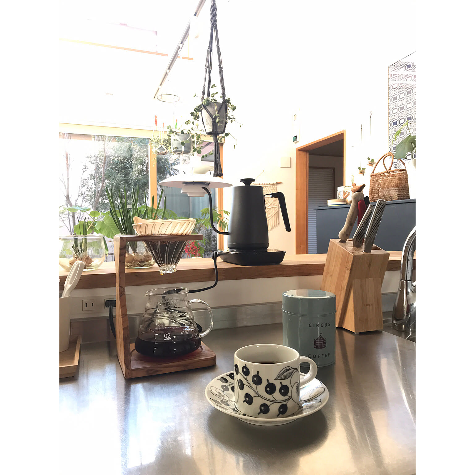 Temperature-control gooseneck kettle next to a HARIO pour-over stand.