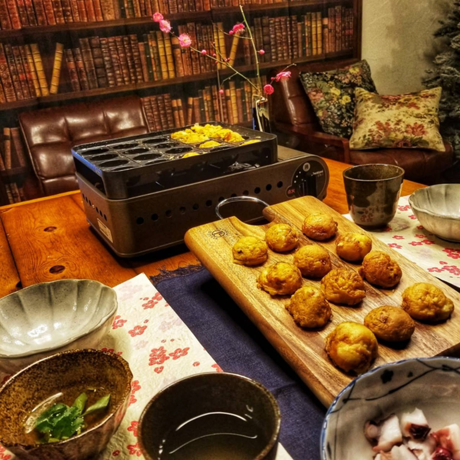 An Iwatani Enutako-style gas takoyaki grill used for hot tabletop cooking in a Japanese home.