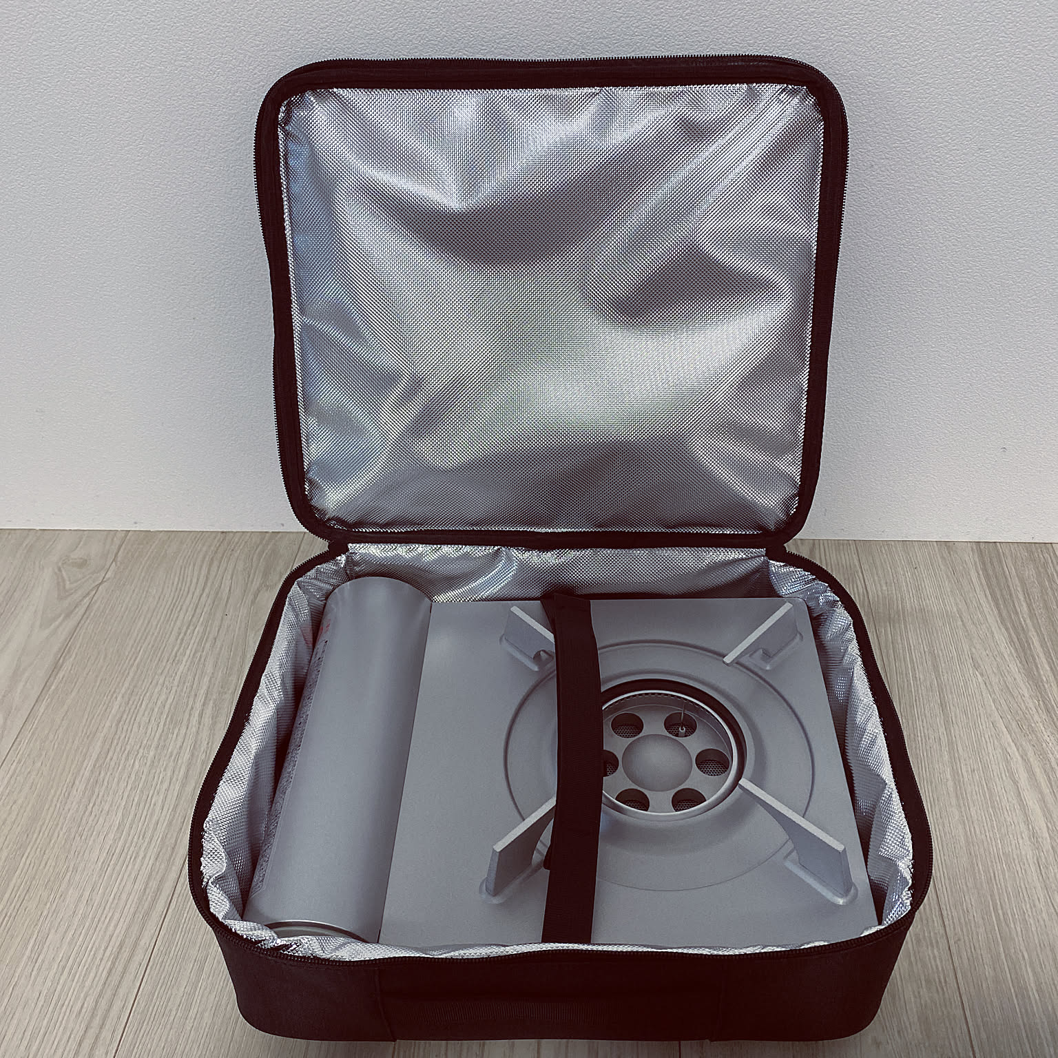 An Iwatani Eco Premium cassette stove stored in an insulated carrying bag.