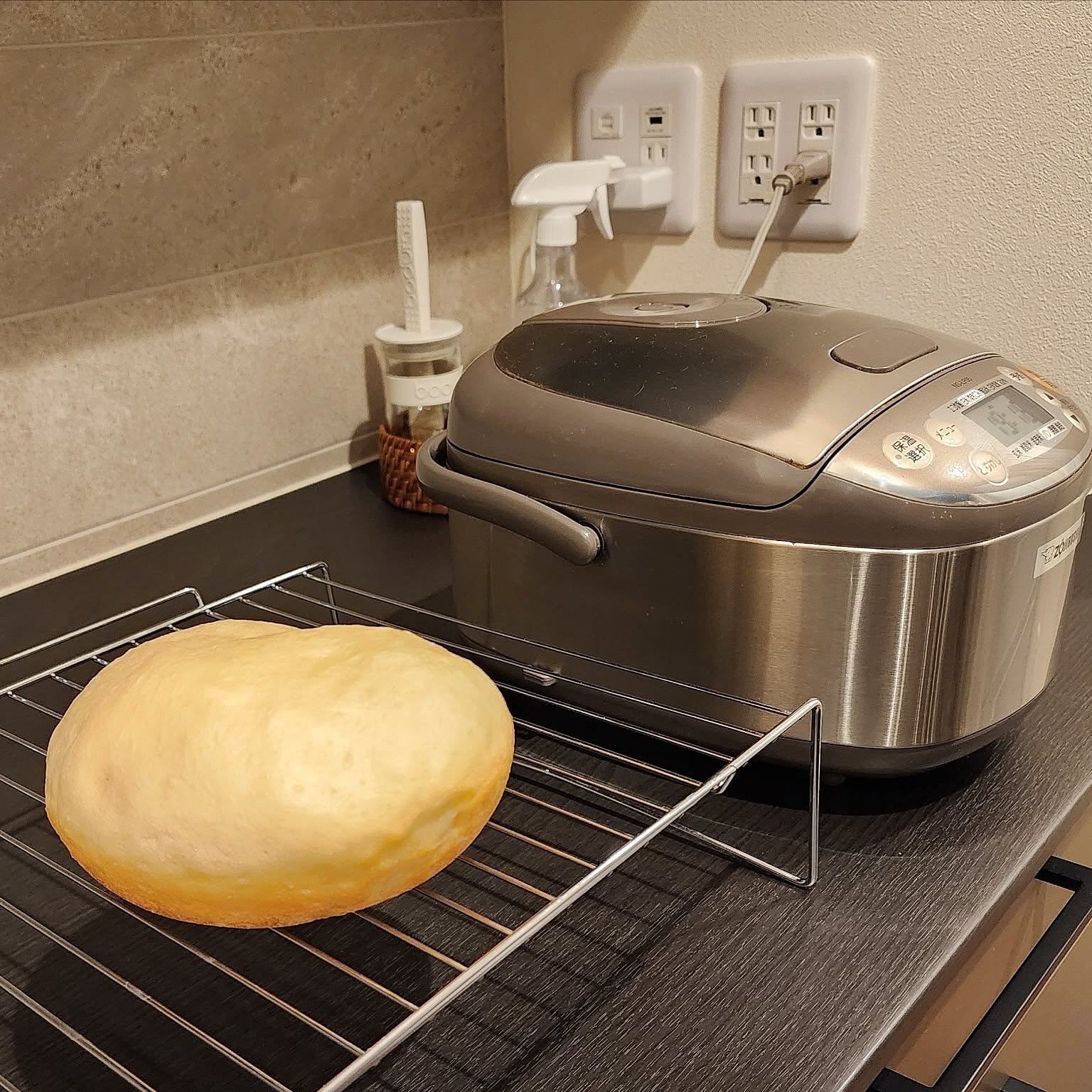 An older Zojirushi 3-cup rice cooker shown beside a freshly baked loaf.
