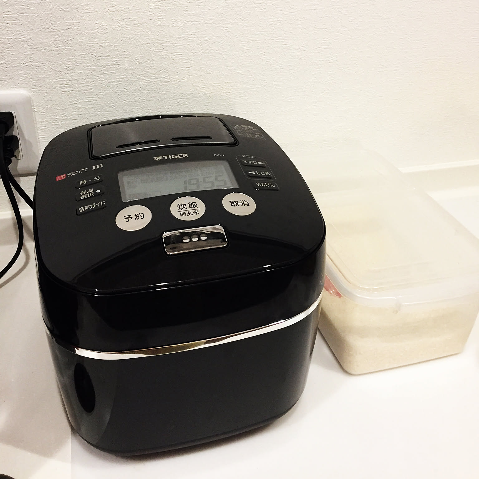 A black Tiger pressure IH rice cooker shown close-up with the control panel visible.