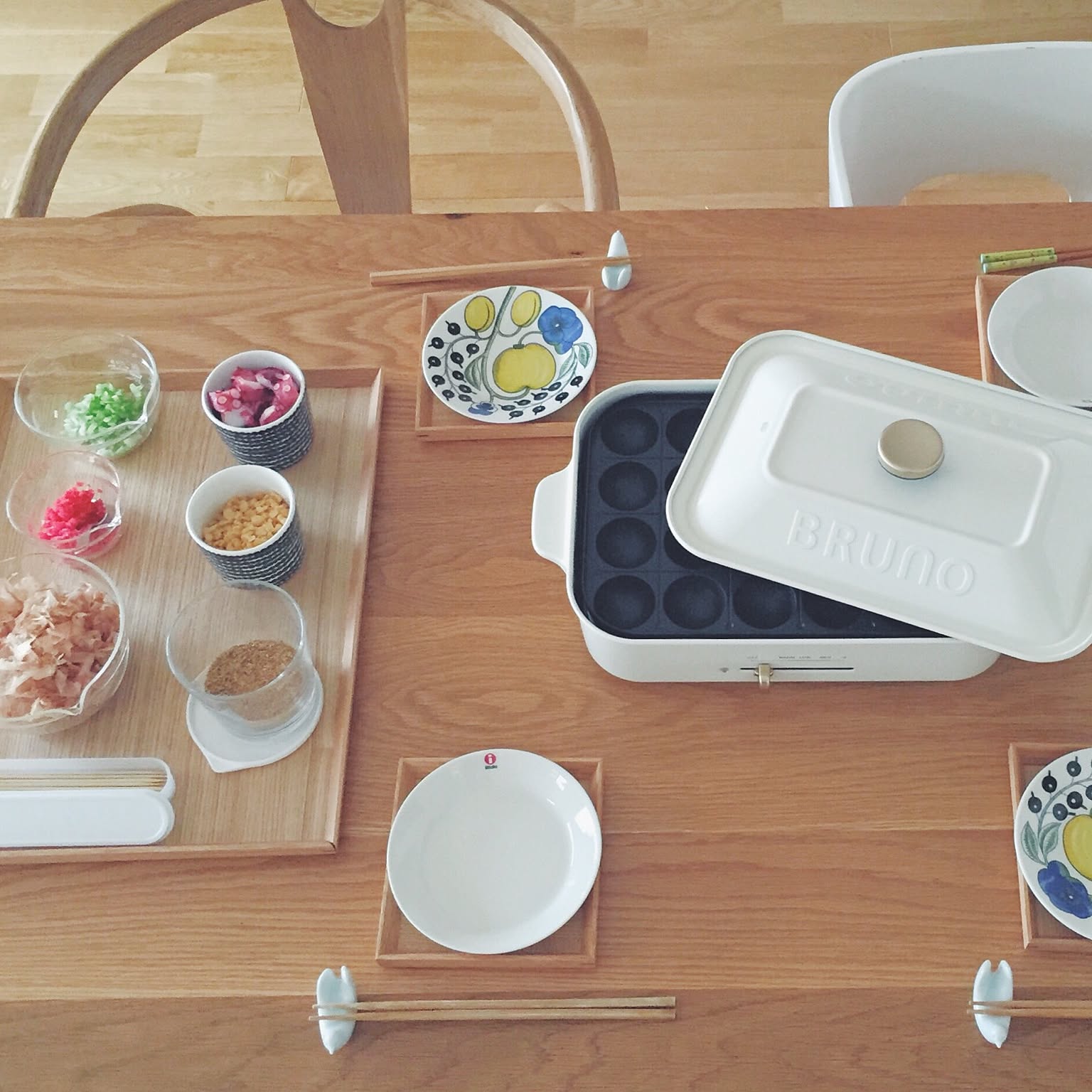 A white BRUNO compact hot plate with a takoyaki plate and party ingredients.