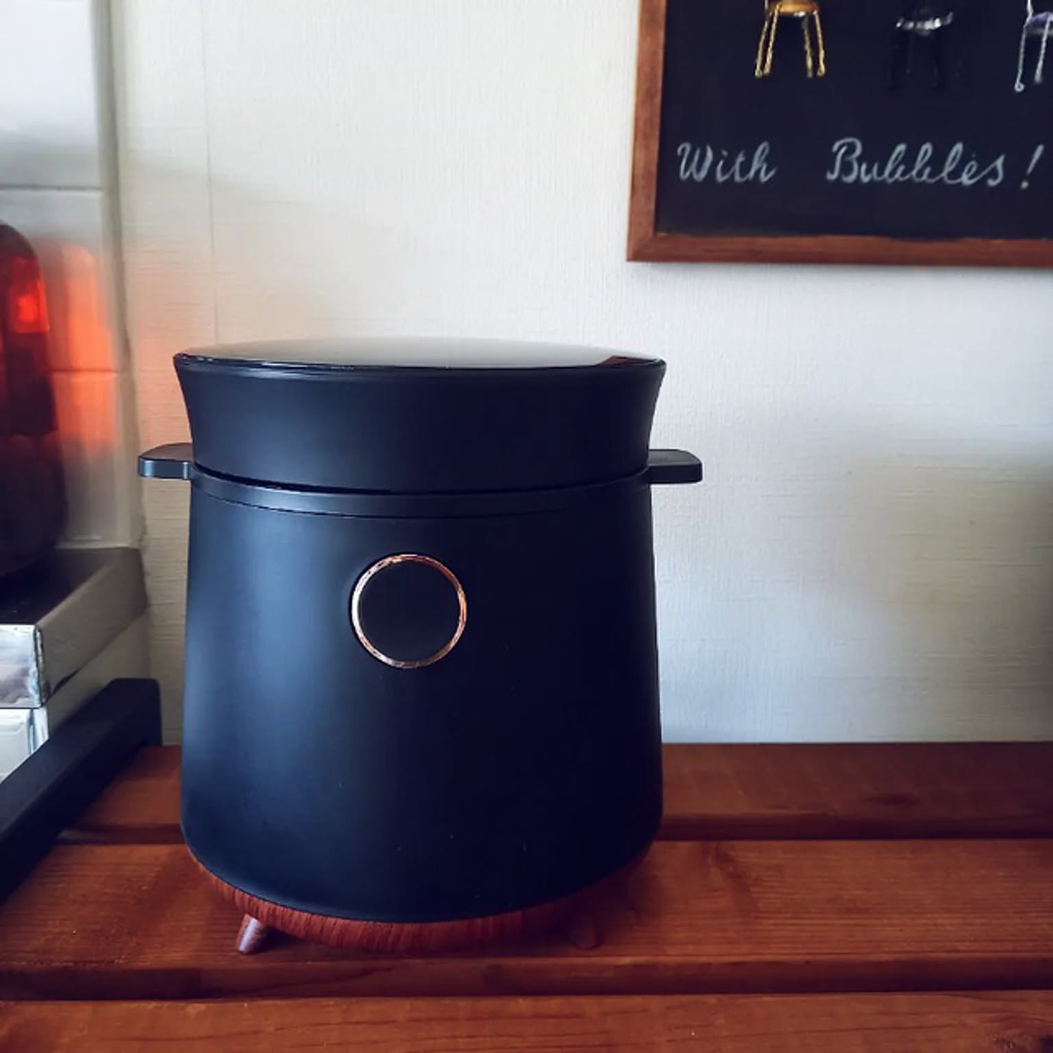 A black wood-accented ROOMMATE TokyoDeco 2-go rice cooker shown on a counter.