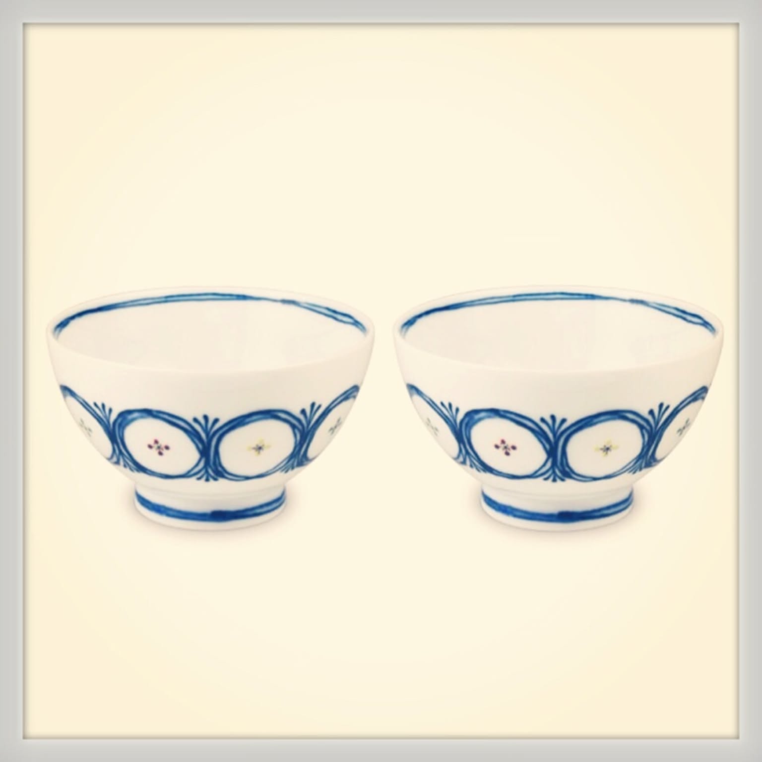 Pair of blue and white Japanese small donburi bowls on a light background.