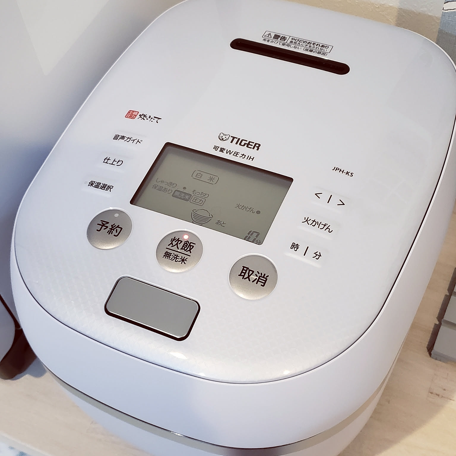 A pale blue Tiger pressure IH rice cooker shown from above with the control panel visible.