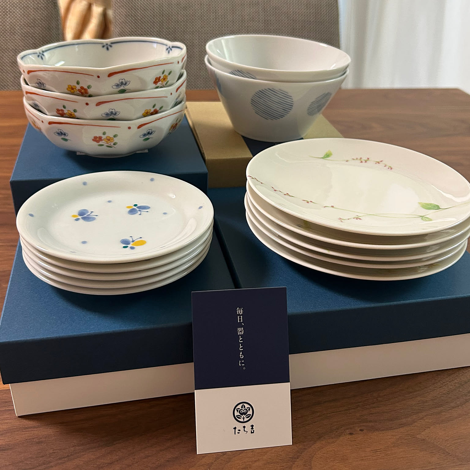 Stacked Japanese small plates, side plates, and bowls displayed as a set.