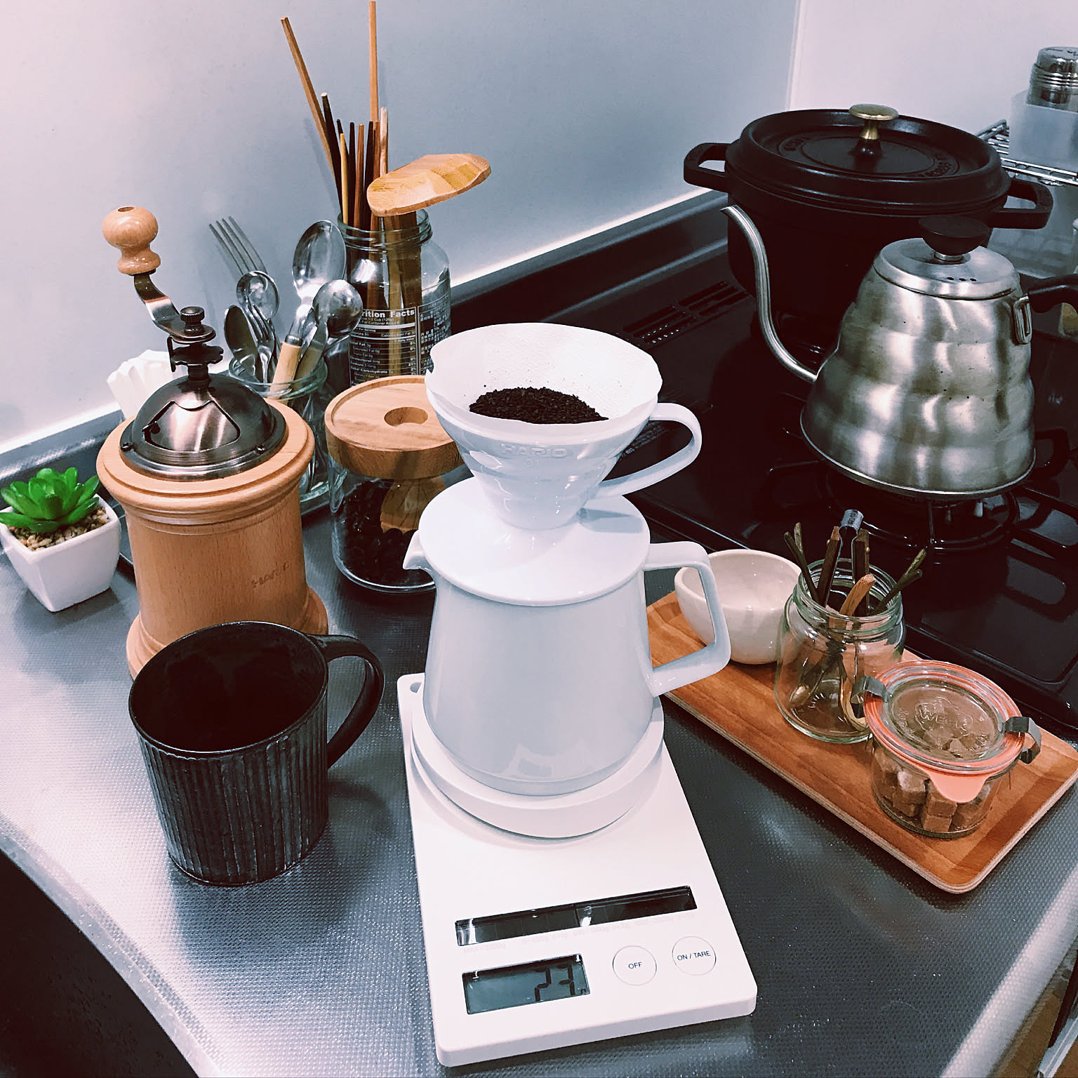HARIO V60 dripper setup with a drip kettle, grinder, scale, server, and mug.