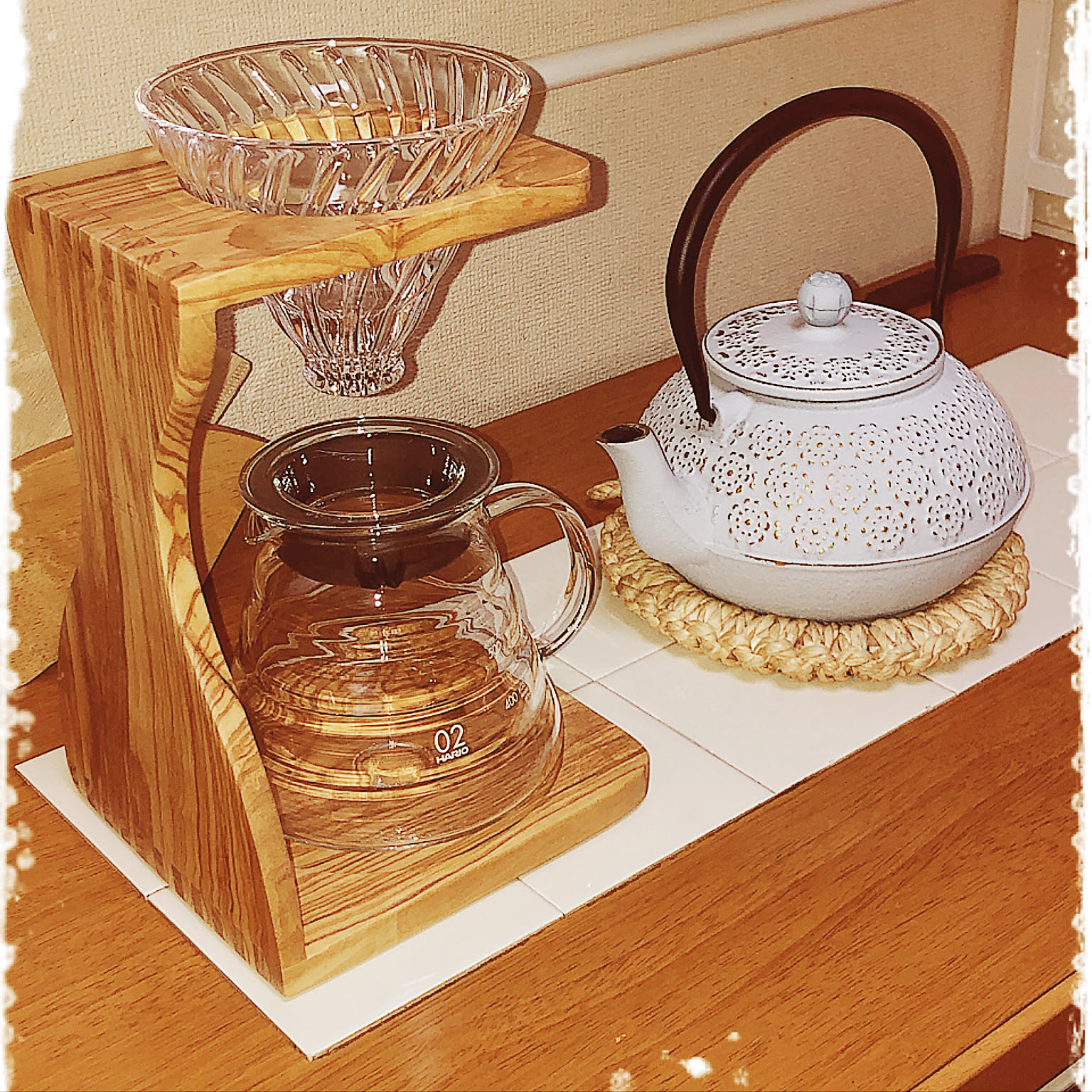 HARIO V60 olive wood stand set with a clear dripper and server.