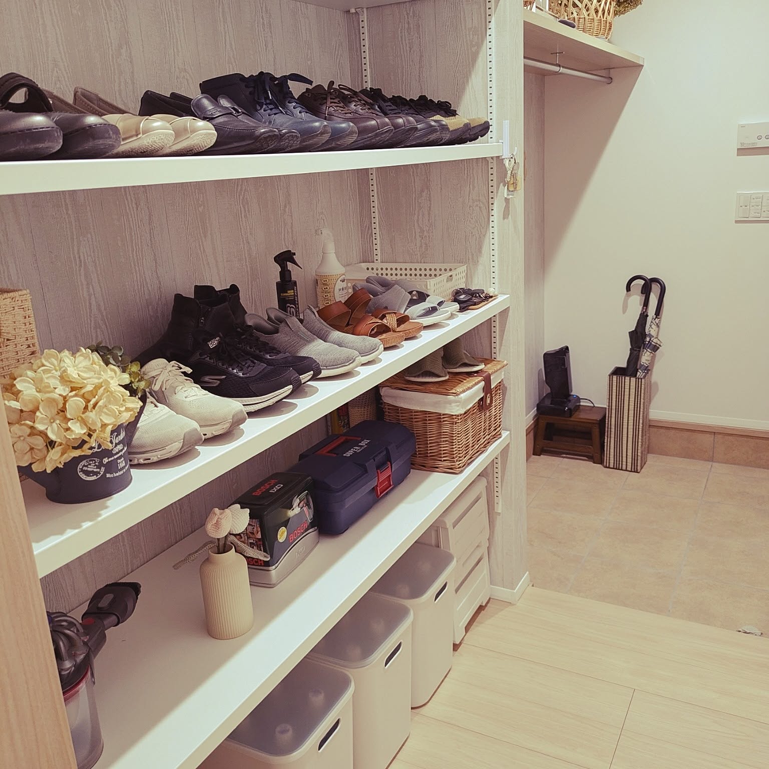 A shoe closet with shelves for shoes, baskets, boxes, and emergency supplies.