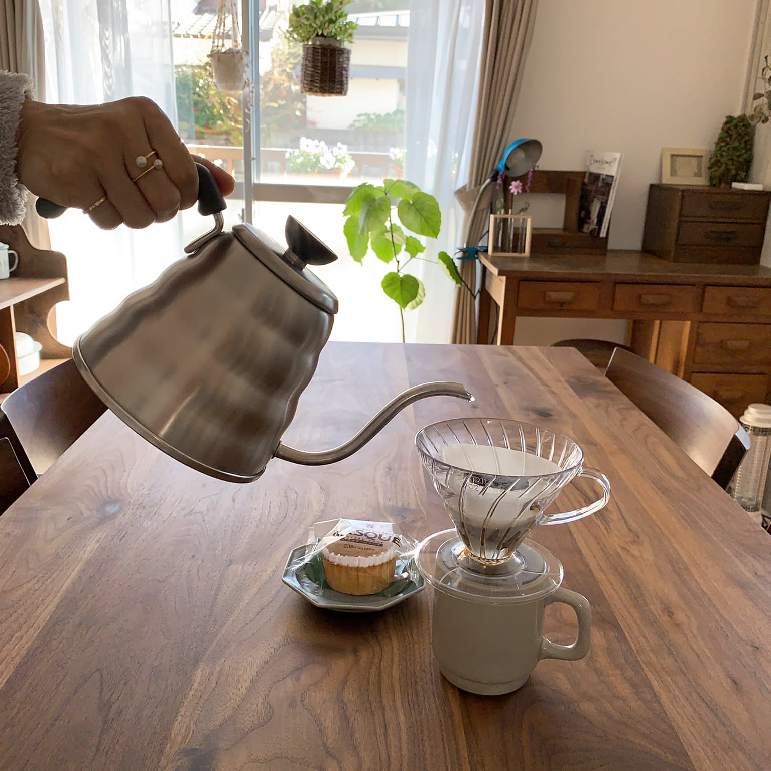 A close shot of a Hario V60 Buono drip kettle on a vintage table.
