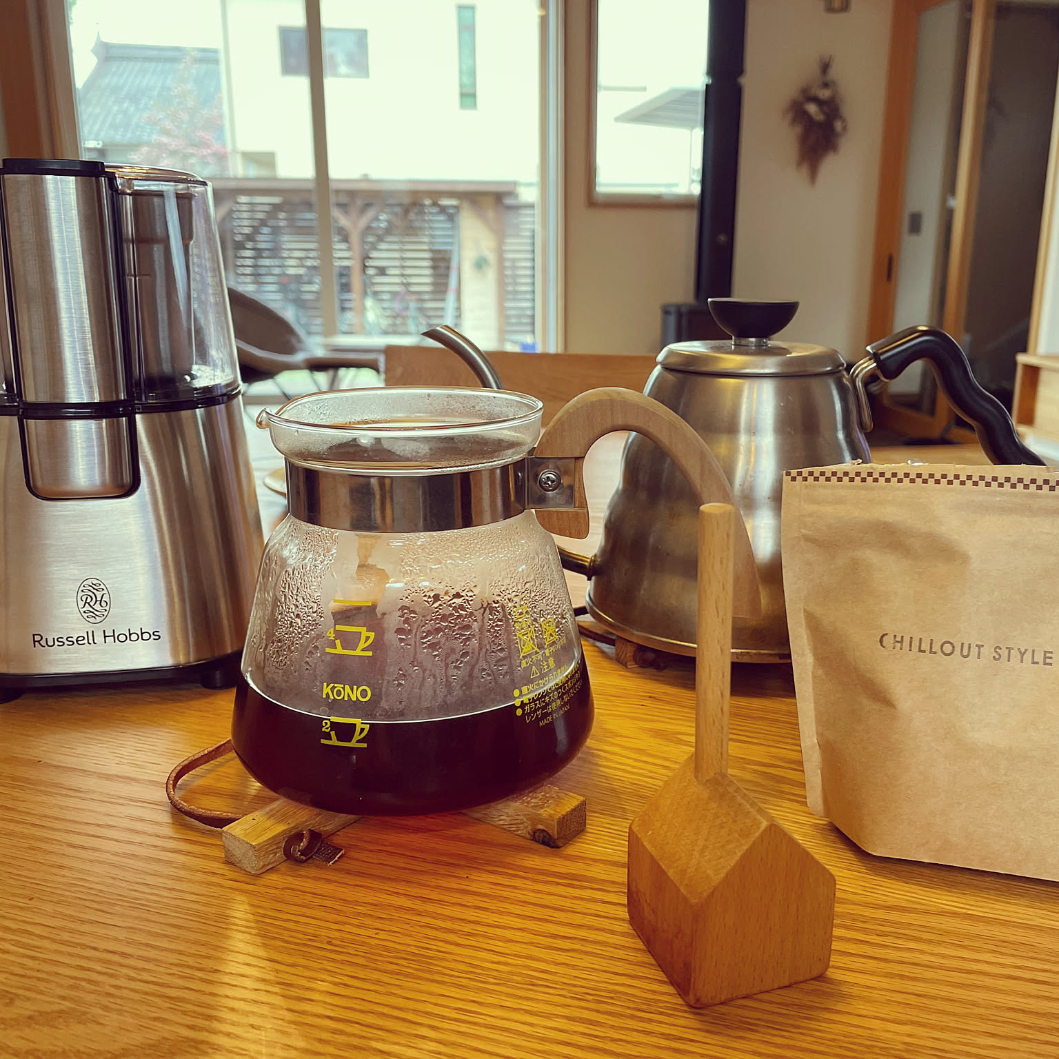 HARIO V60 Buono-style drip kettle beside a server, grinder, and coffee bag.