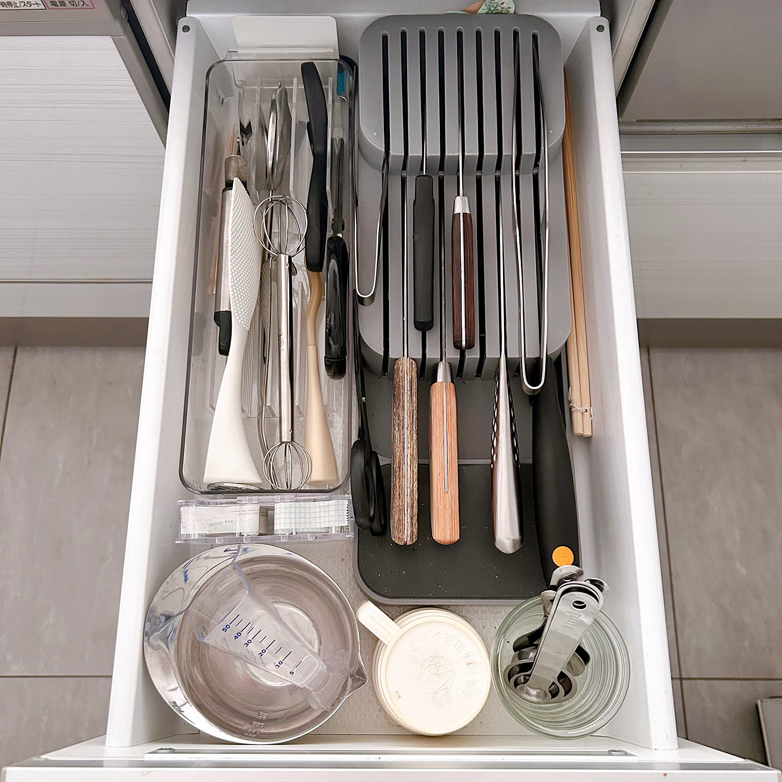 Kitchen drawer with knives stored safely in a slotted knife organizer.
