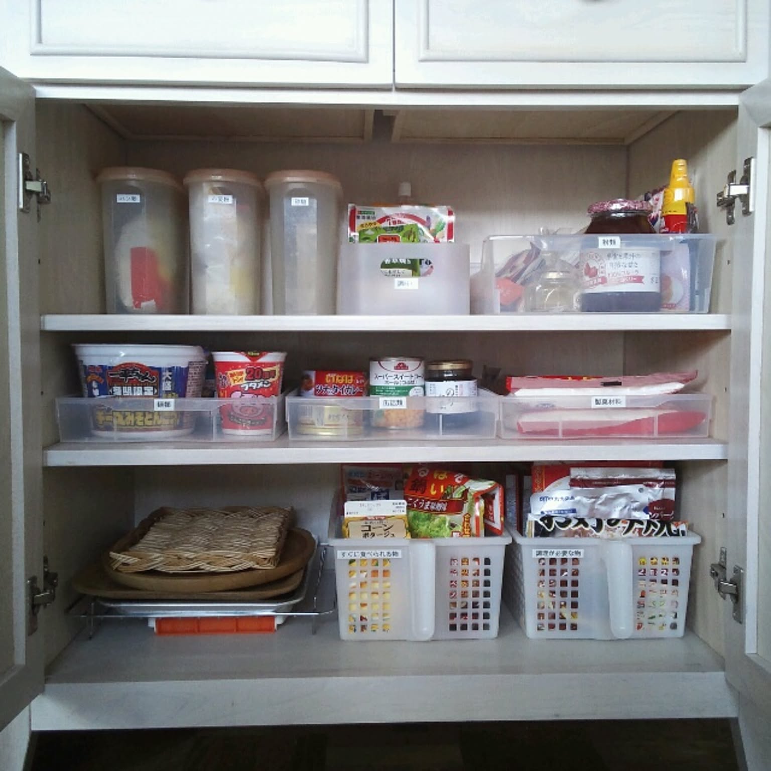 A kitchen cabinet pantry grouped into flour, seasonings, noodles, cans, and retort food bins.
