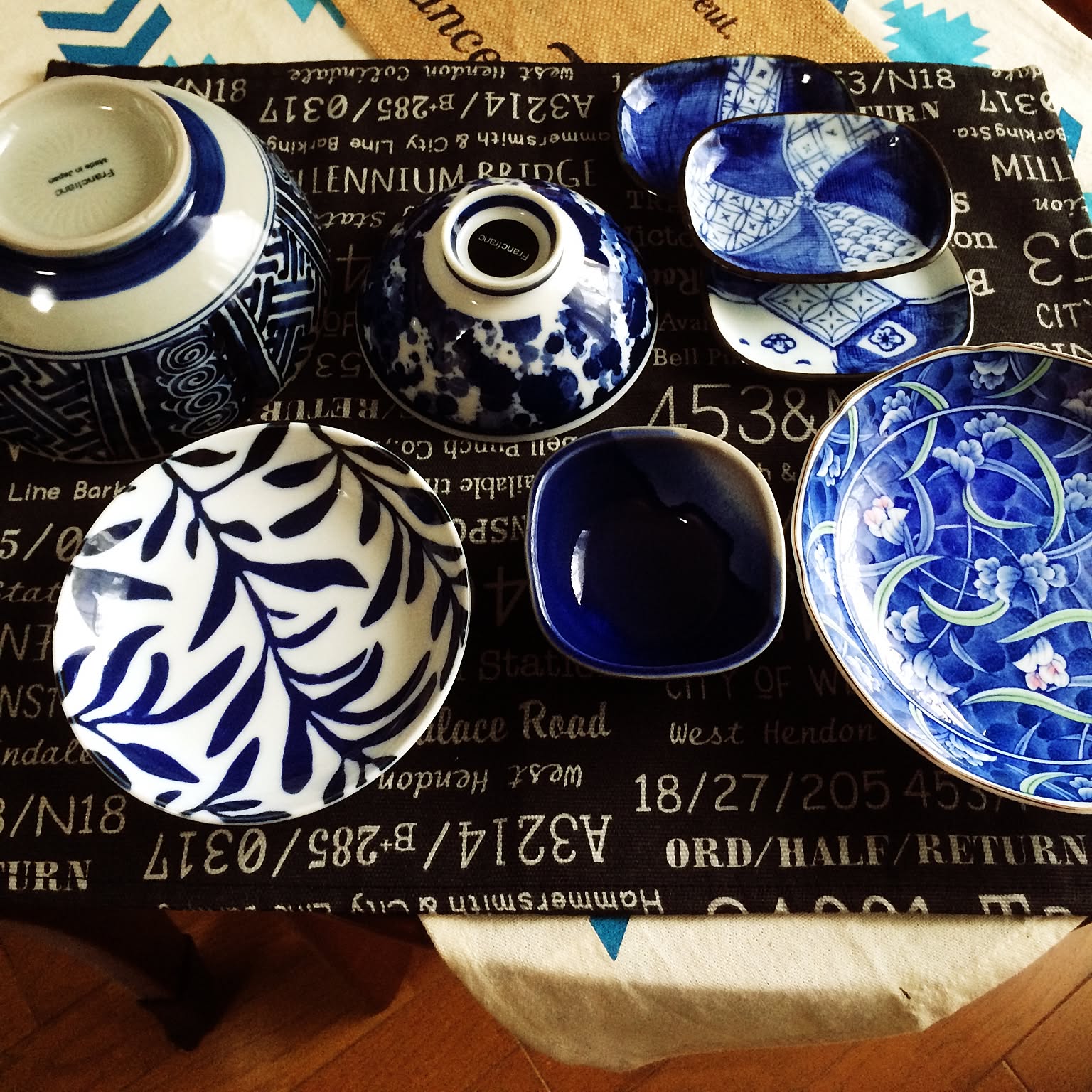 Japanese bowls, small plates, and side dishes arranged together.