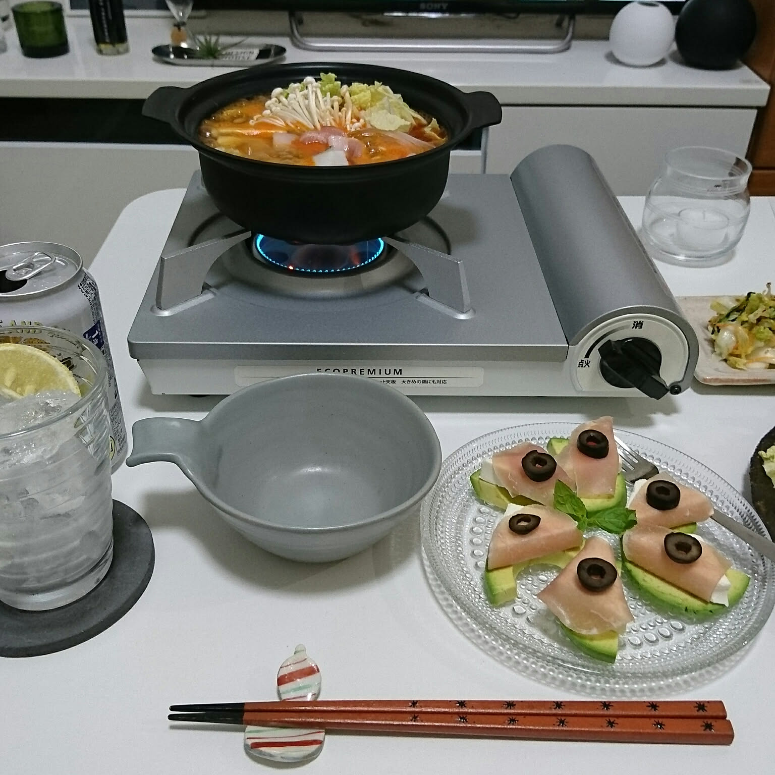 An Iwatani Eco Premium cassette stove used for a small hot-pot dinner on a table.