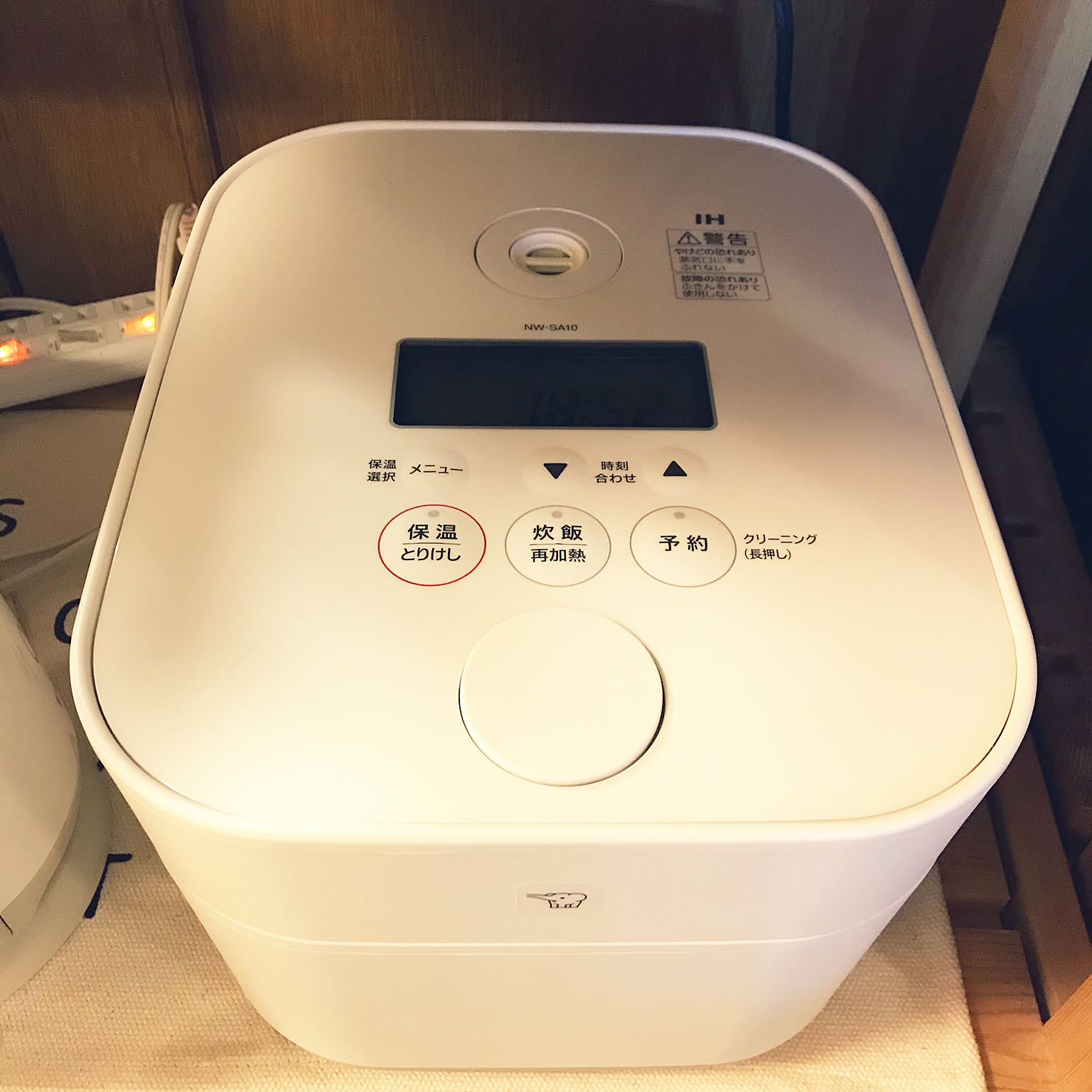Close-up of a white Zojirushi STAN. IH rice cooker showing its clean minimalist design