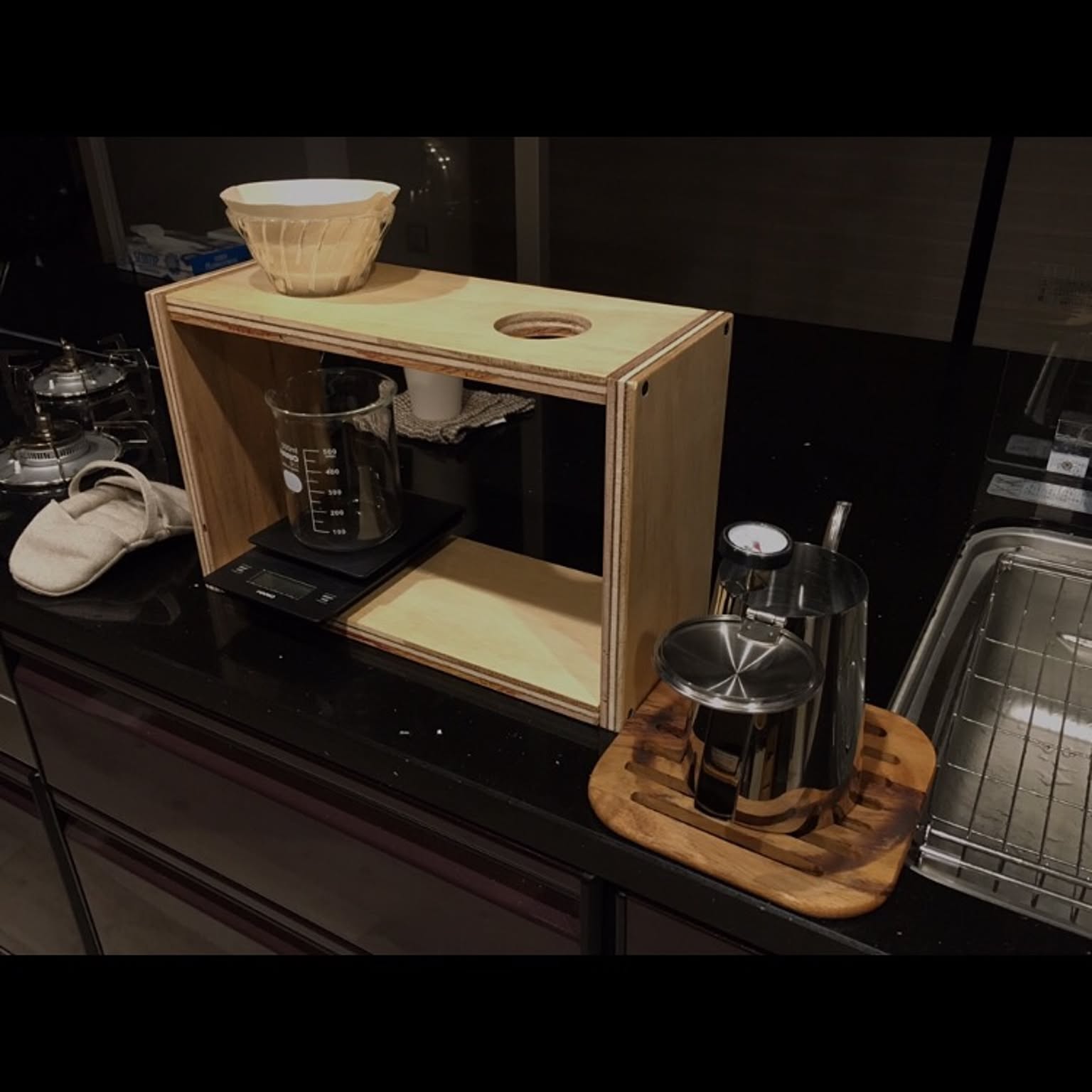 A HARIO glass V60 dripper and server arranged in a compact coffee station.